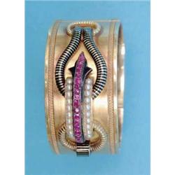 A Continental 19th century gold hinged bangle, the tied silk cord effect front with black enamel...