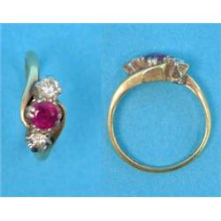 A gold 3-stone crossover ring, set with a ruby and 2 diamonds...
