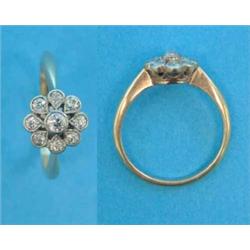 An 18ct gold 9-stone diamond set flowerhead cluster ring...