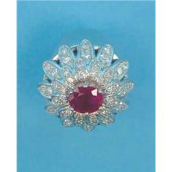 A modern white metal flowerhead dress ring, with central oval ruby and diamond set 'petals'...