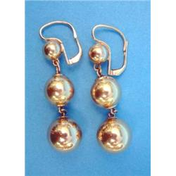 A pair of gold drop earrings, each designed as a line of 3 graduated spheres on chain connections...