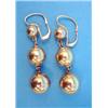 Image 1 : A pair of gold drop earrings, each designed as a line of 3 graduated spheres on chain connections...