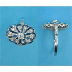 A diamond and sapphire dress ring, the oval plaque millegrain set with sworls of round cut diamon...