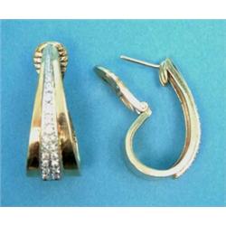 A pair of 18k gold hoop earrings, each set with a tapered line of round cut diamonds...