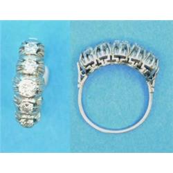 A 5-stone diamond ring, claw-set in white metal...