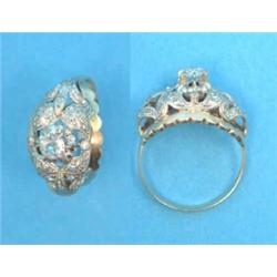 A Continental gold ring, claw-set with a single diamond in a pierce work leaf design bezel set sm...