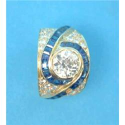 A diamond and sapphire dress ring, the wide band set with a central old brilliant cut diamond (ap...