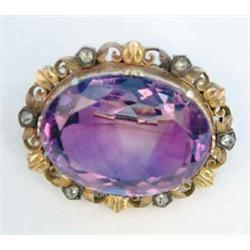 A Victorian gold and amethyst brooch, the oval amethyst in a scrolled frame set 6 rose cut diamon...