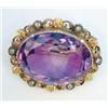 Image 1 : A Victorian gold and amethyst brooch, the oval amethyst in a scrolled frame set 6 rose cut diamon...