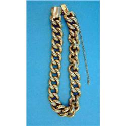 A gold curb link bracelet, 23.5grms...
