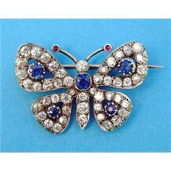 A Victorian design gold and silver butterfly brooch, set diamonds, sapphires and cabochon rubies...