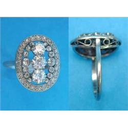 A platinum and diamond oval plaque ring, claw-set with a row of 3 old brilliant cut diamonds in o...