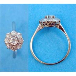 A white gold 9-stone diamond circular cluster ring...