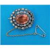 Image 1 : A Victorian oval brooch, set with a central foil backed topaz in a 2-row border of rose cut diamo...