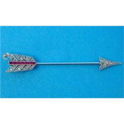 An Art Deco arrow shaped jabot pin, set diamonds and calibre cut rubies, 1.75ins...