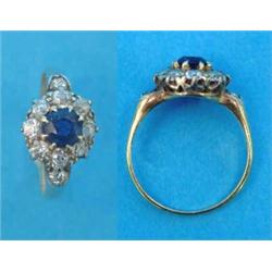 A gold claw-set sapphire and diamond circular cluster ring, each shoulder set with a further diam...