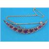 Image 1 : A late Victorian gold crescent brooch, set 9 graduated round cut rubies spaced by pairs of small...