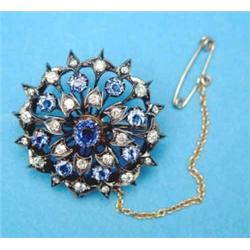 A late Victorian gold and silver circular openwork brooch, designed as a chrysanthemum head, set...