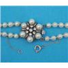 Image 1 : A 2-row graduated cultured pearl necklace, with silver flowerhead clasp, set cultured pearls and...
