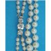 Image 1 : A 2-row graduated cultured pearl necklace, the white gold clasp claw-set with 3 old brilliant cut...