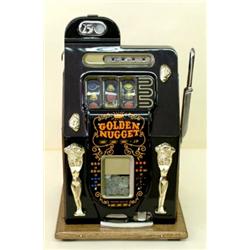 TWENTY-FIVE CENT SLOT MACHINE, The parcel gilt face painted with "Golden Nugget", oak side pane...