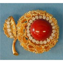 STUNNING CORAL AND DIAMOND BROOCH, Centered by a cabochon coral and set with thirty brilliant c...