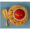 Image 1 : STUNNING CORAL AND DIAMOND BROOCH, Centered by a cabochon coral and set with thirty brilliant c...