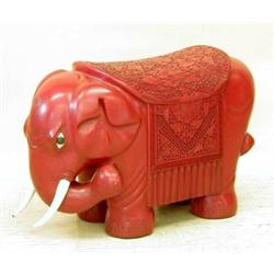 PAIR OF MOLDED CINNABAR AND COMPOSITION ELEPHANT SEATS, Each with floral design saddle and clot...