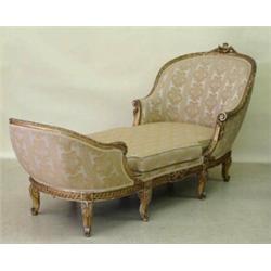 LOUIS XV STYLE CARVED AND GILT WOOD CHAISE LOUNGE, French. 19th Century. Each curved end contin...