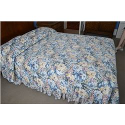 Floral bed linens in blue, greens and yellows, double size. with brown curtain