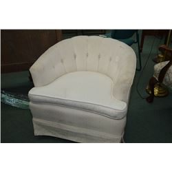 White upholstered swivelling bucket chair