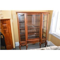 Mid 20th Century single door china/curio cabinet with scroll supports and storage drawer