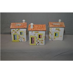 Three hand painted house motif canisters