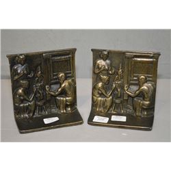 A pair of bronze figural bookends