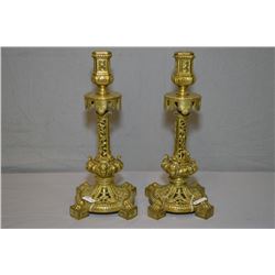 Pair of vintage cast brass candlesticks with fretwork bases, portrait and paw detailing