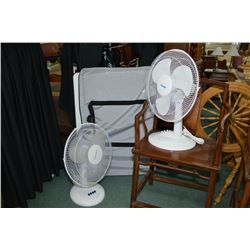 Two table top electrical fans and a floor standing white board in soft case