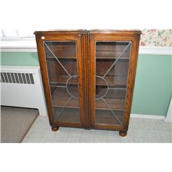 English oak two door curio cabinet with leaded glass panels