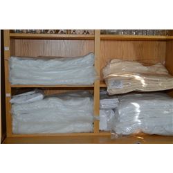 Selection of hotel brand new supplies including sheets, towels and tablecloths