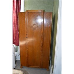 Quarter cut oak single door wardrobe with carved decorated cartouche