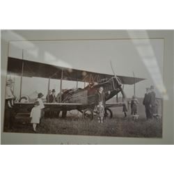 Framed black and white photo likely at an air show of a Curtis JN-4 bi-plane April 1922, Edmonton