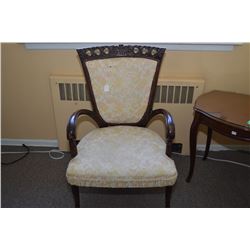 Antique open arm upholstered parlour chair with delicately carved supports and back decoration