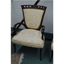 Antique open arm upholstered parlour chair with delicately carved supports and back decoration