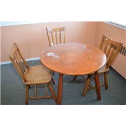 Round maple dinette table and four arrow back chairs