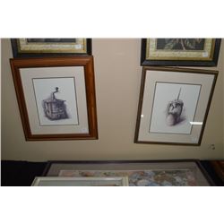 Two framed prints one of a coffee grinder and one of a butter churn