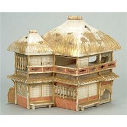 A Japanese earthenware incense burner in the form of a thatched cottage, the lower part with styl...