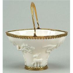 A Chinese blanc-de-chine and gilt-metal-mounted libation cup sprigged with pine, prunus and mythi...