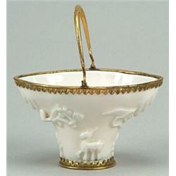 A Chinese blanc-de-chine and gilt-metal-mounted libation cup sprigged with pine, prunus and mythi...