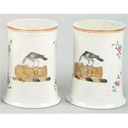 A pair of Chinese famille-rose tankards, the tall finely potted sides with strap handles and rui...