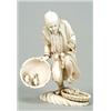 Image 1 : A Japanese ivory carving of a peasant, standing by and also holding a basket with frogs, on rockw...