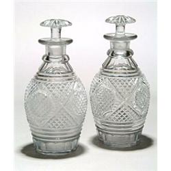 A pair of cut ovoid spirit decanters and mushroom stoppers, with a geometric pattern field of fin...